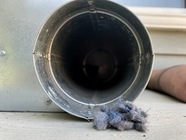 Glocester Dryer Vent Cleaning technician using specialized equipment to clear severe dryer vent blockage in Glocester
